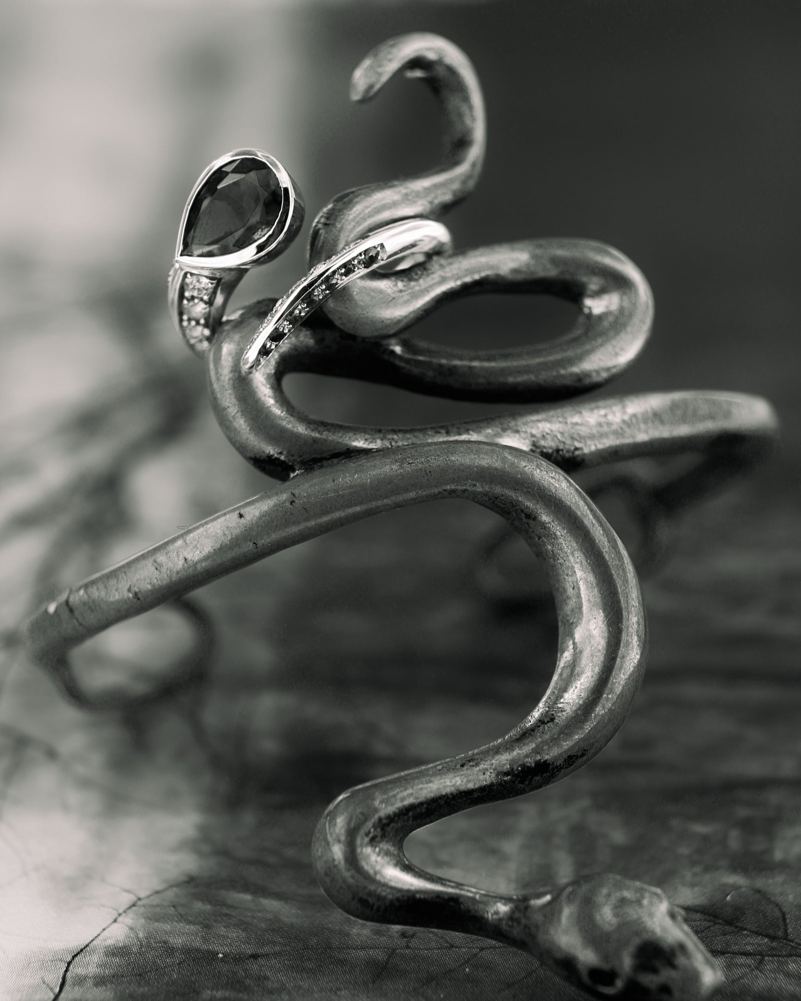 Anello serpente in oro bianco con rubellite centrale e diamanti, creazione artigianale Merù Gioielli.