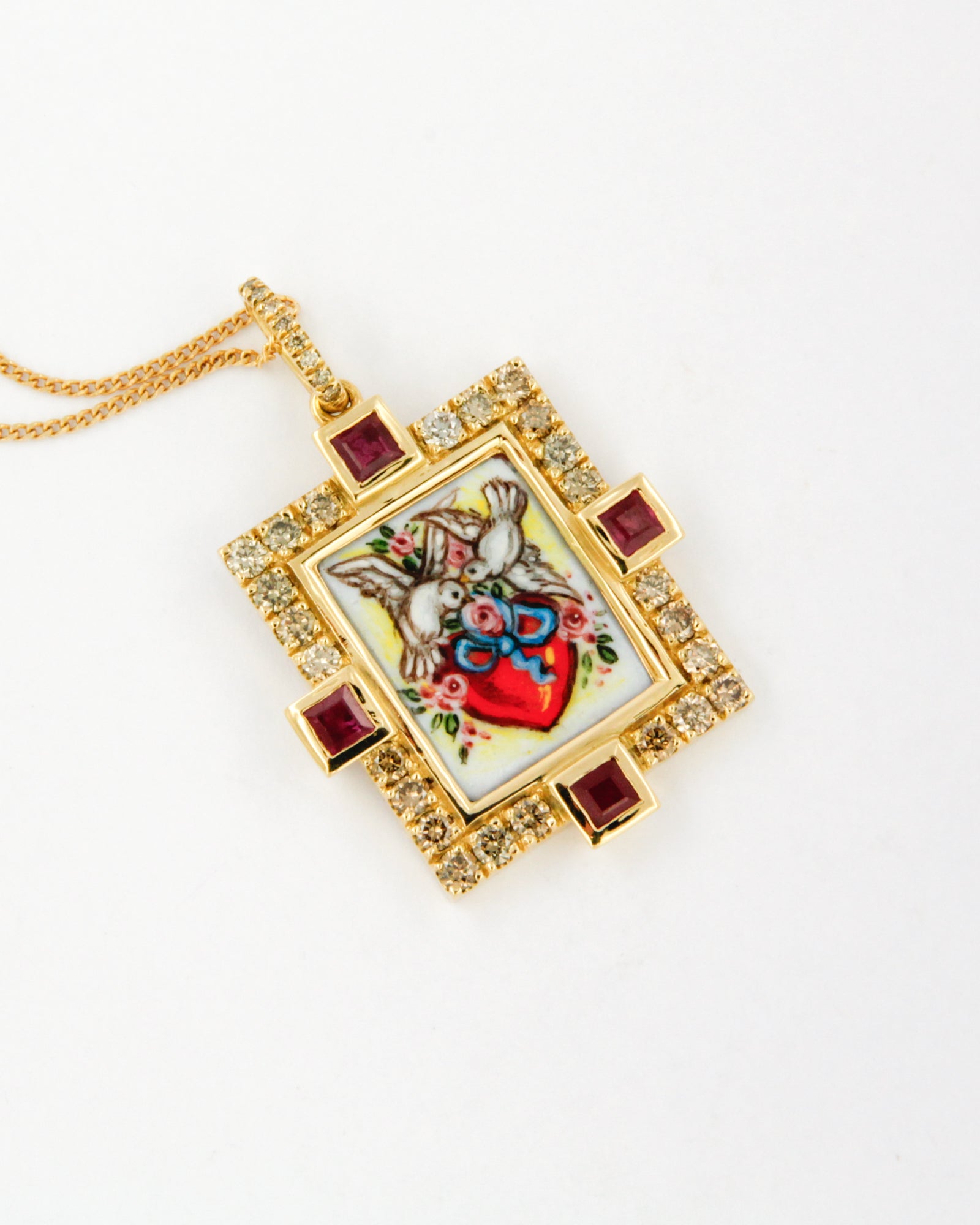 Ciondolo in oro giallo 18K con colombe e fiori su cuore in smalto a fuoco dipinto a mano, cornice con diamanti e rubini.