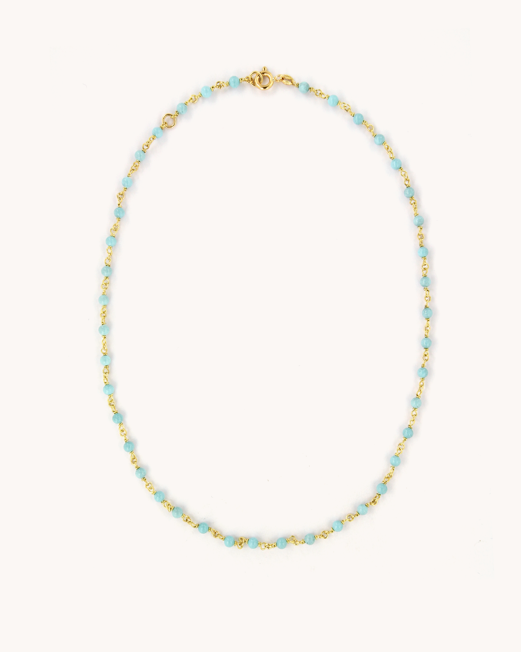 Collana in oro giallo 18 carati ,impreziosita da perline in pasta di turchese.