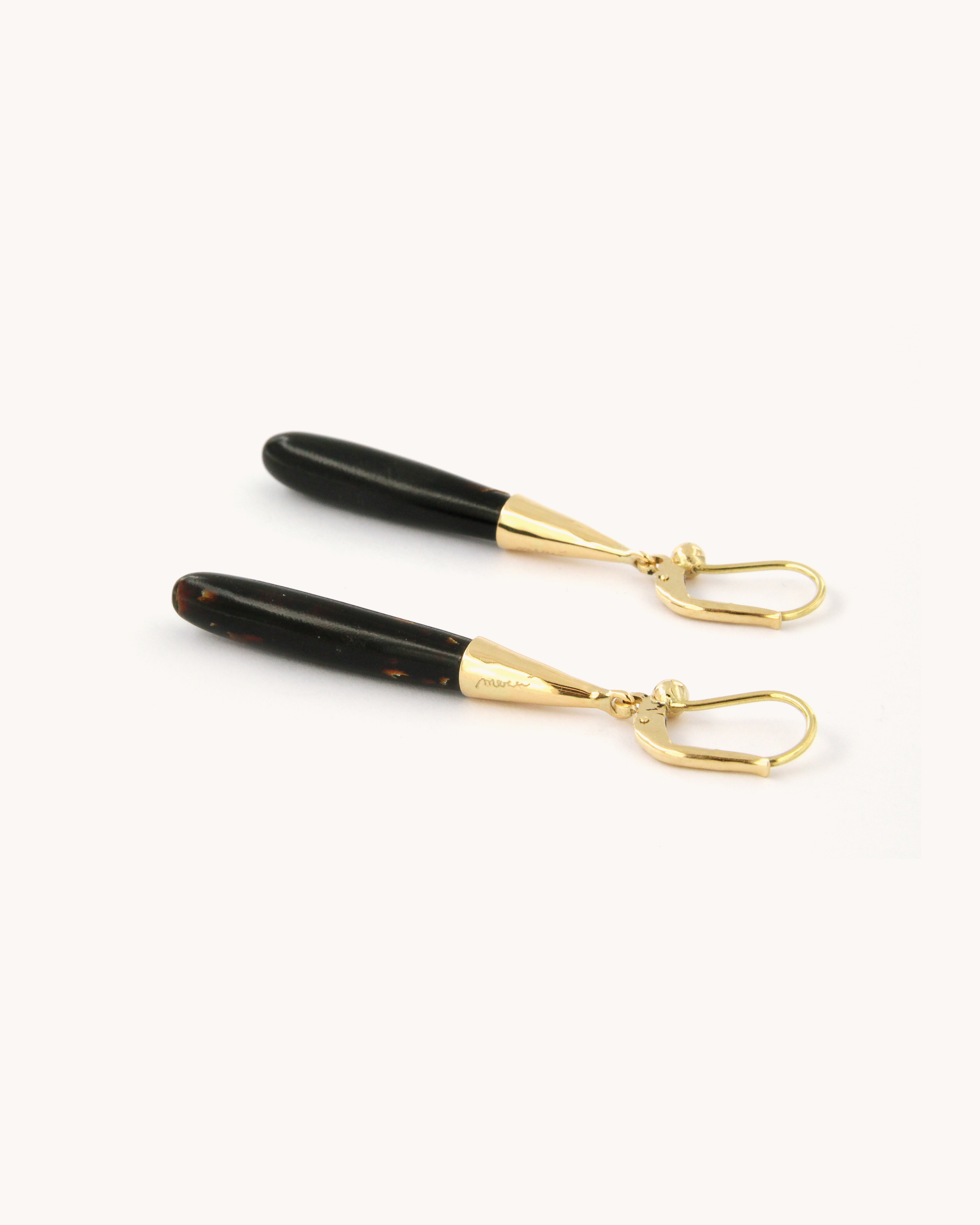 Orecchini pendenti in oro giallo 18K con corallo nero naturale dalla forma allungata.