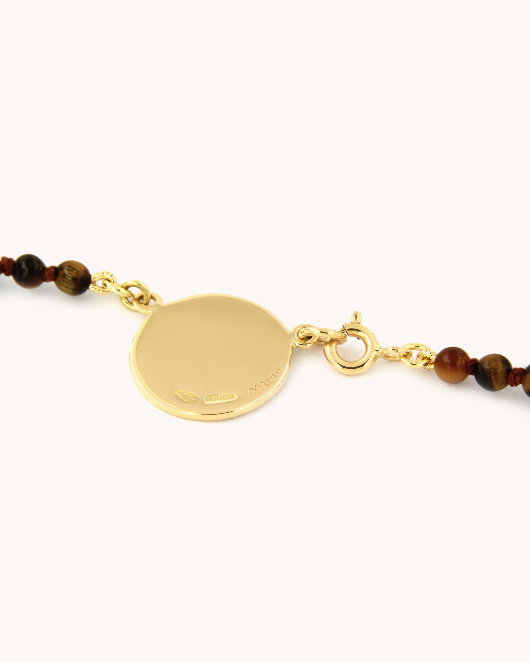 Dettaglio della collana Coloris con perline di occhio di tigre e piastra con rosa dipinta a mano in smalto a fuoco, incorniciata in oro giallo 18 carati.