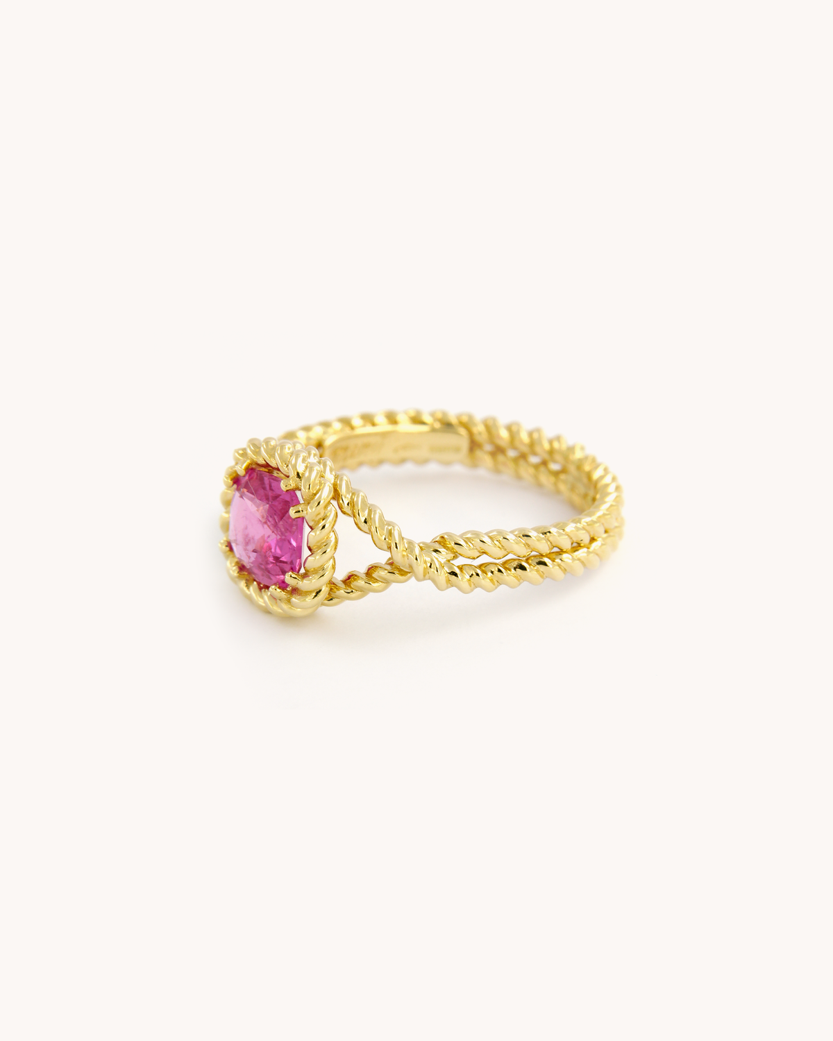 Anello Torchon in oro giallo 18 carati con zaffiro rosa naturale, incastonato in una montatura con lavorazione a corda intrecciata.