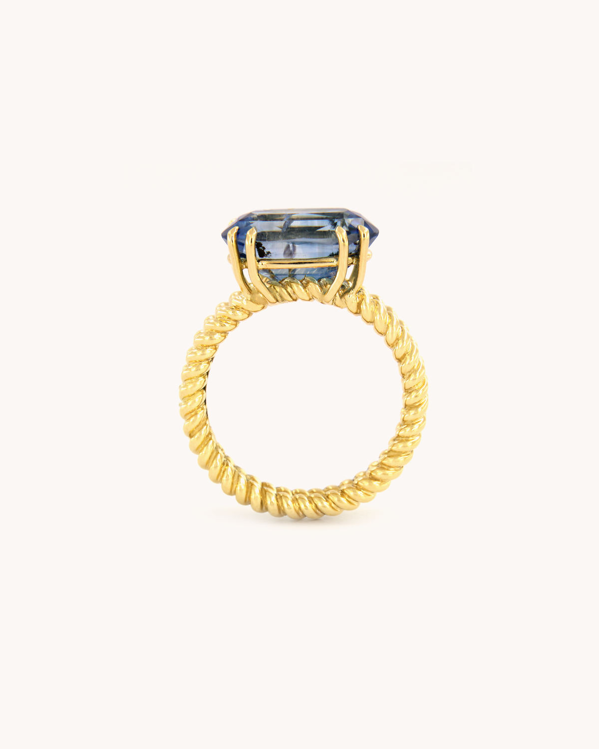 Anello Torchon in oro giallo 18 carati con zaffiro zonato blu dalle variazioni cromatiche naturali, vista frontale.
