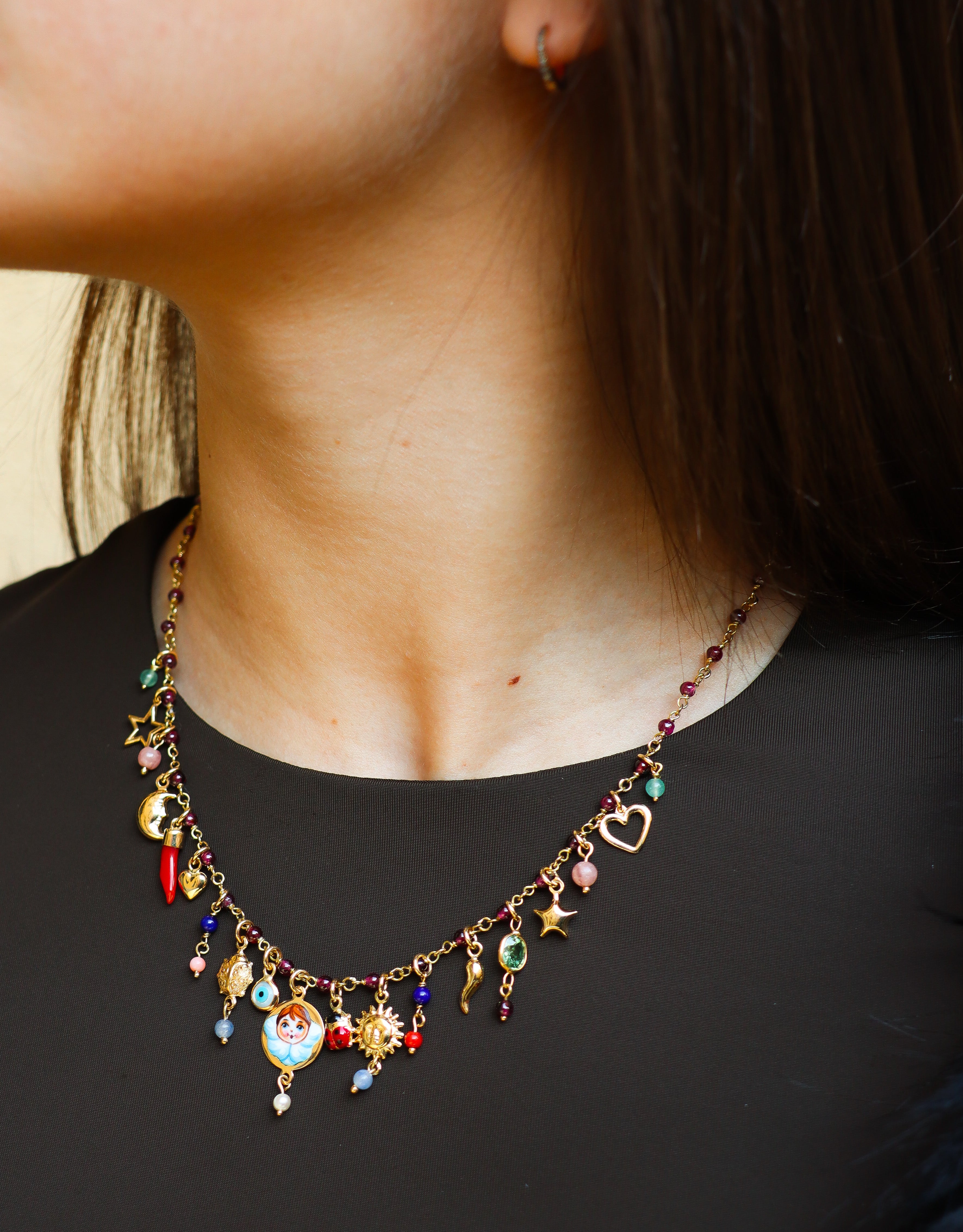 Collana Mediterraneo Angelo Custode in oro giallo 18K con girocollo in granato e ciondoli simbolici decorativi